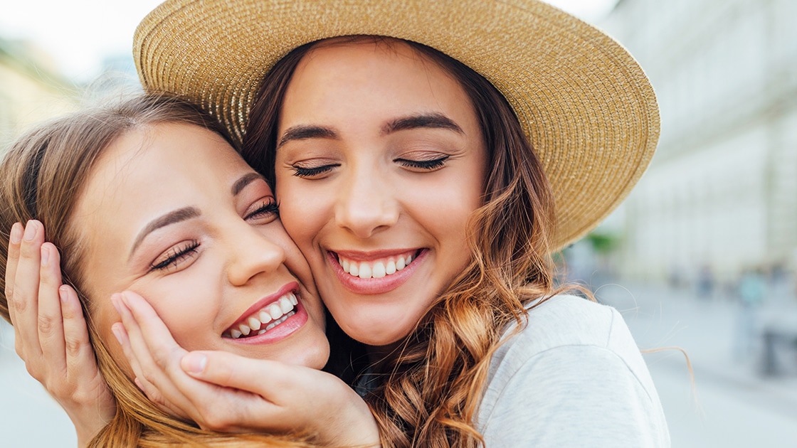 Smiling Girls Hugging Each Other