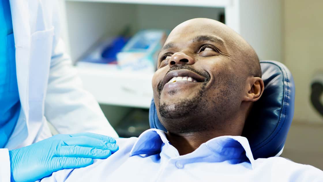 Man in Dental Chair Smliing